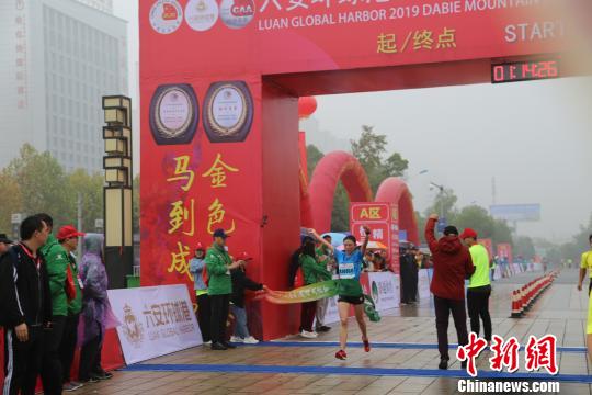 女子半程马拉松冠军、中国选手张德顺冲过赛道瞬间 钟欣 摄